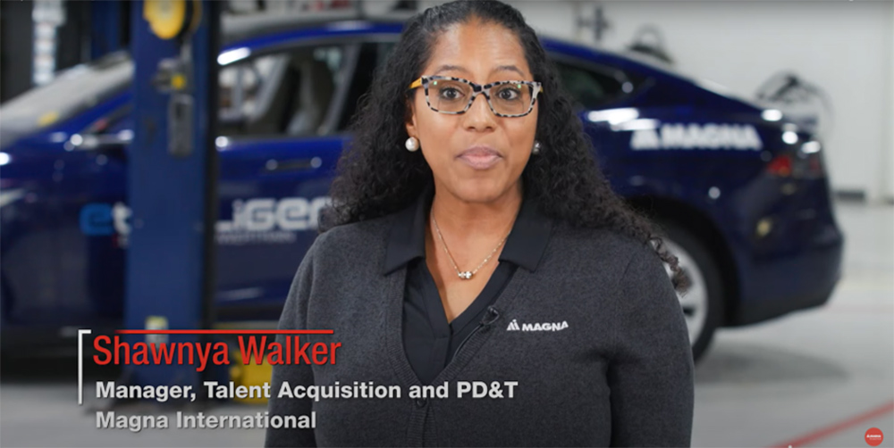 Shawnya Walker talking to the camera in a manufacturing plant