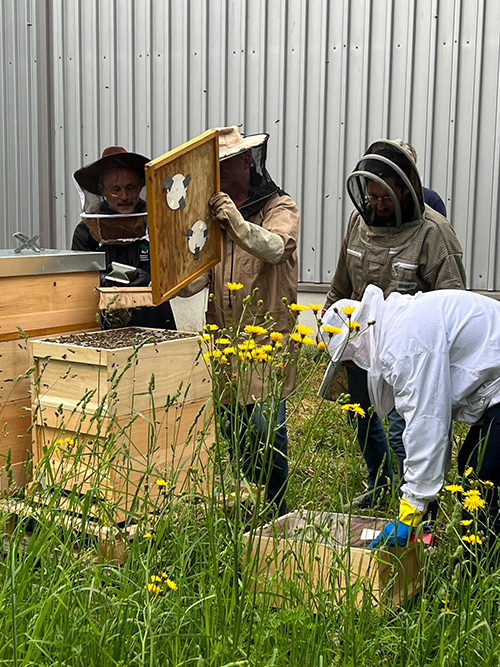 Rhiannon LaForest holding products that were made from wax and honey from their bee hives